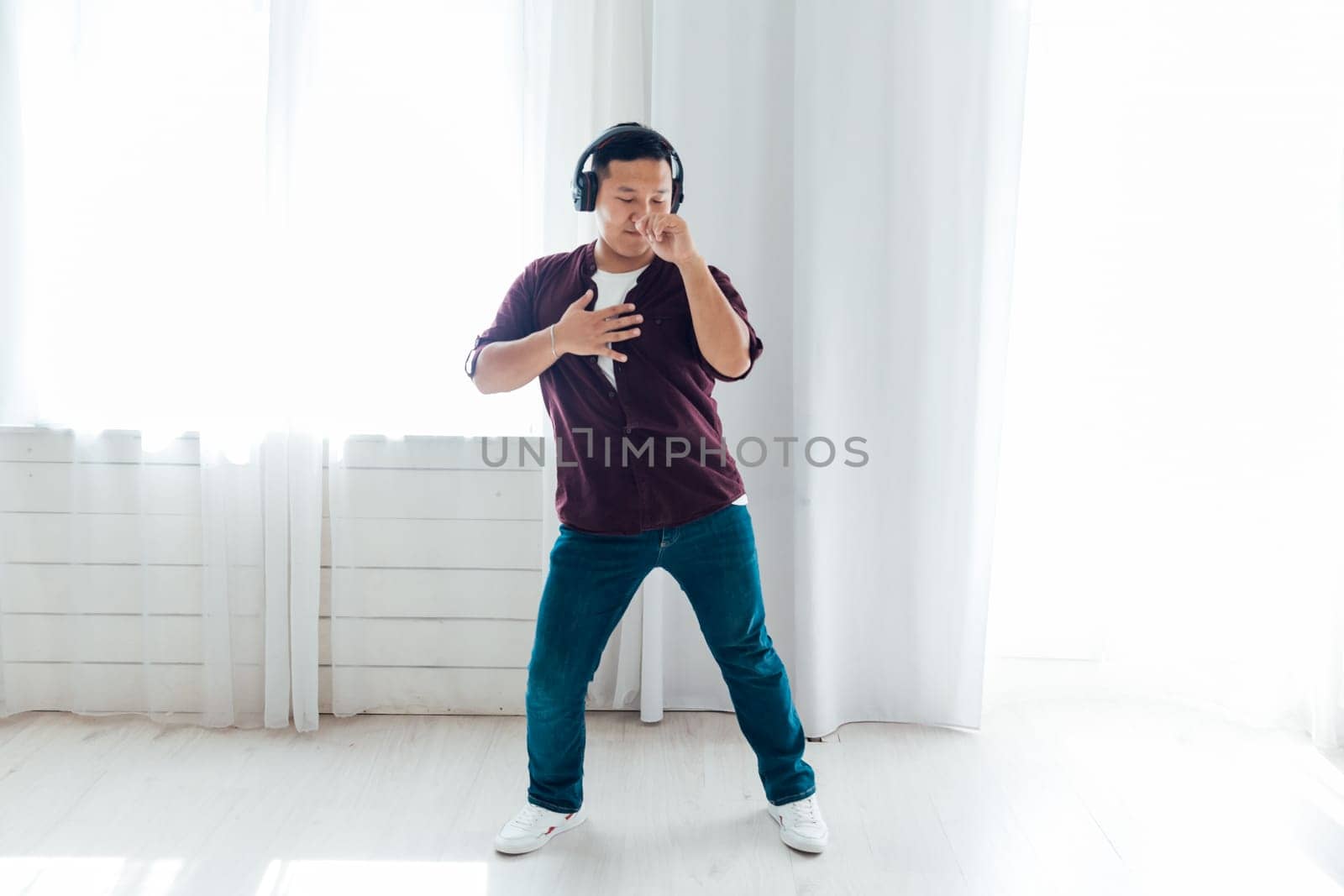 A man listens to music with headphones and dances