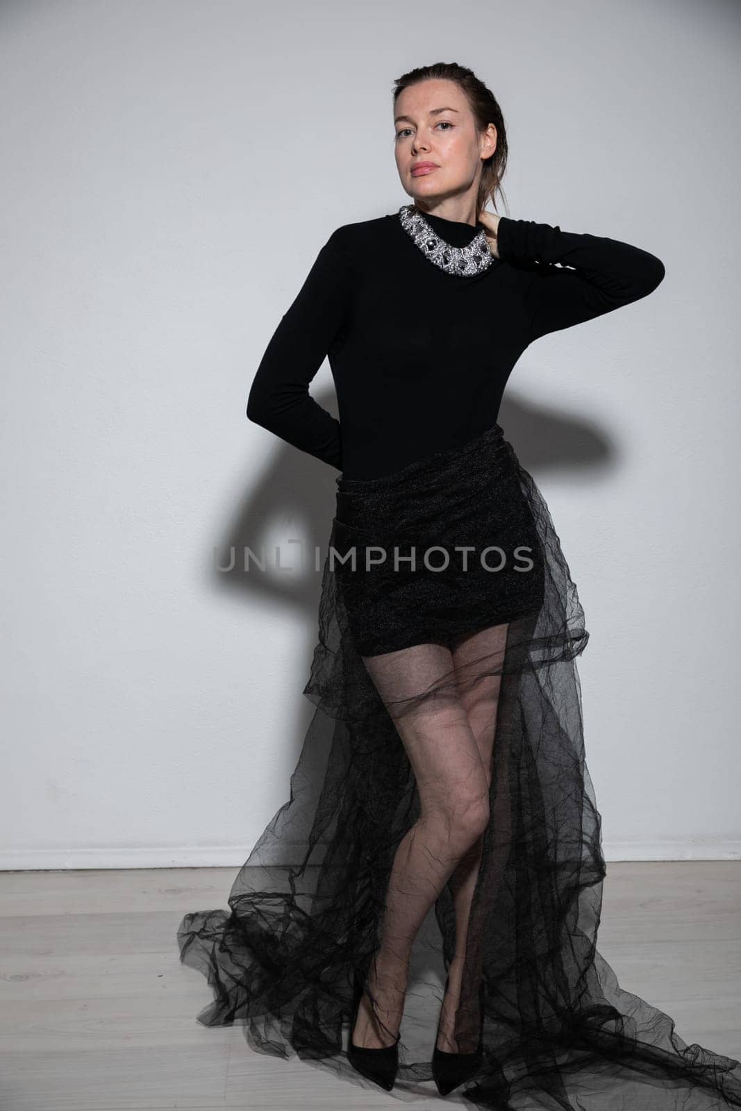 woman in black dress on white background