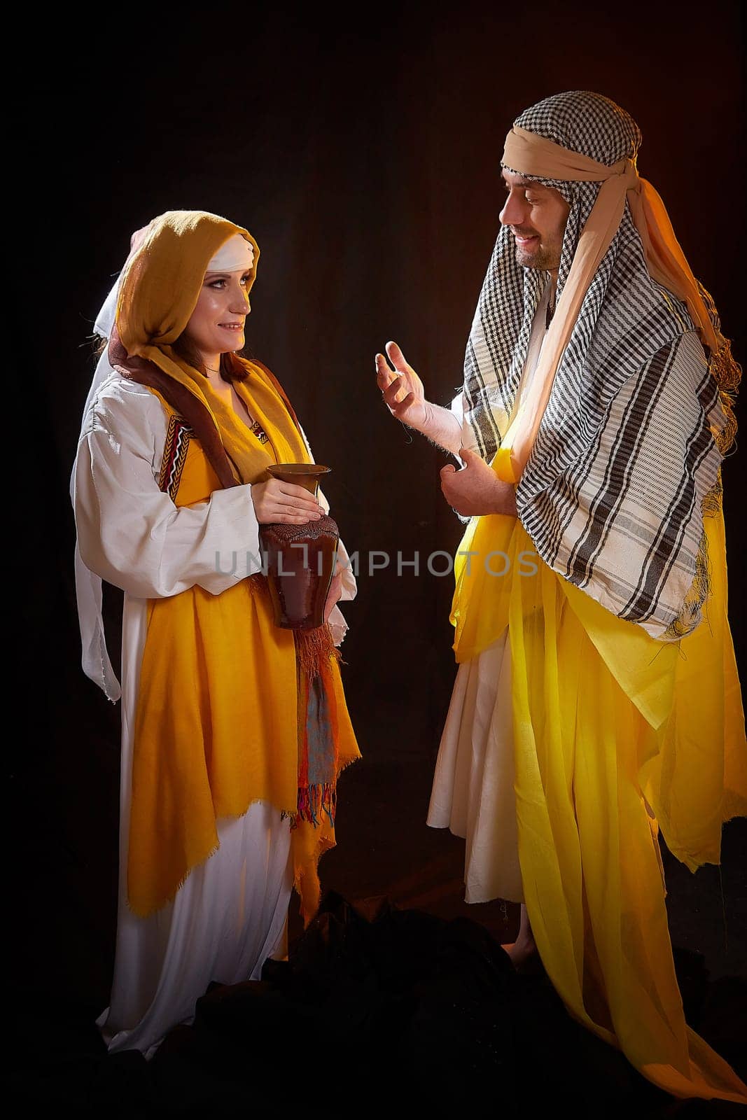 A couple in love or a married couple in stylized Eastern clothing from Israel, Palestine, Iran, Pakistan together. Tender photo session in the style of the Middle East and the Bible