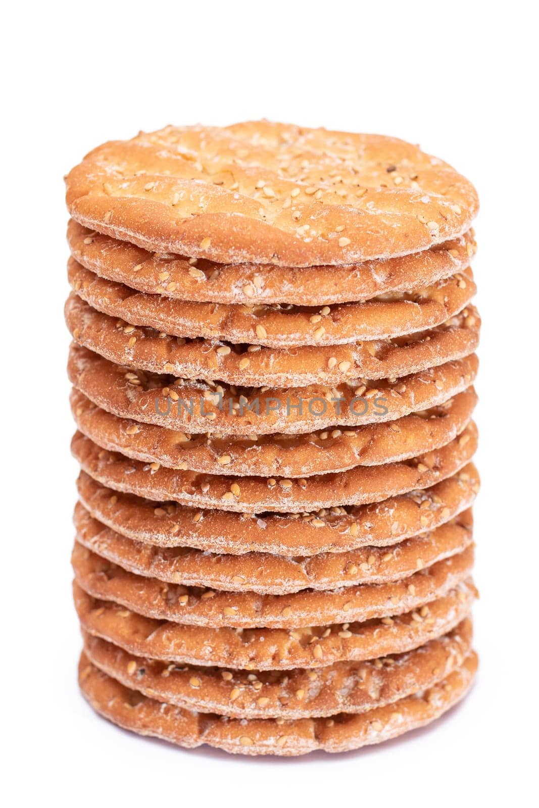 A Stack of Round Salt Crackers with Sesame Isolated on White Background by InfinitumProdux