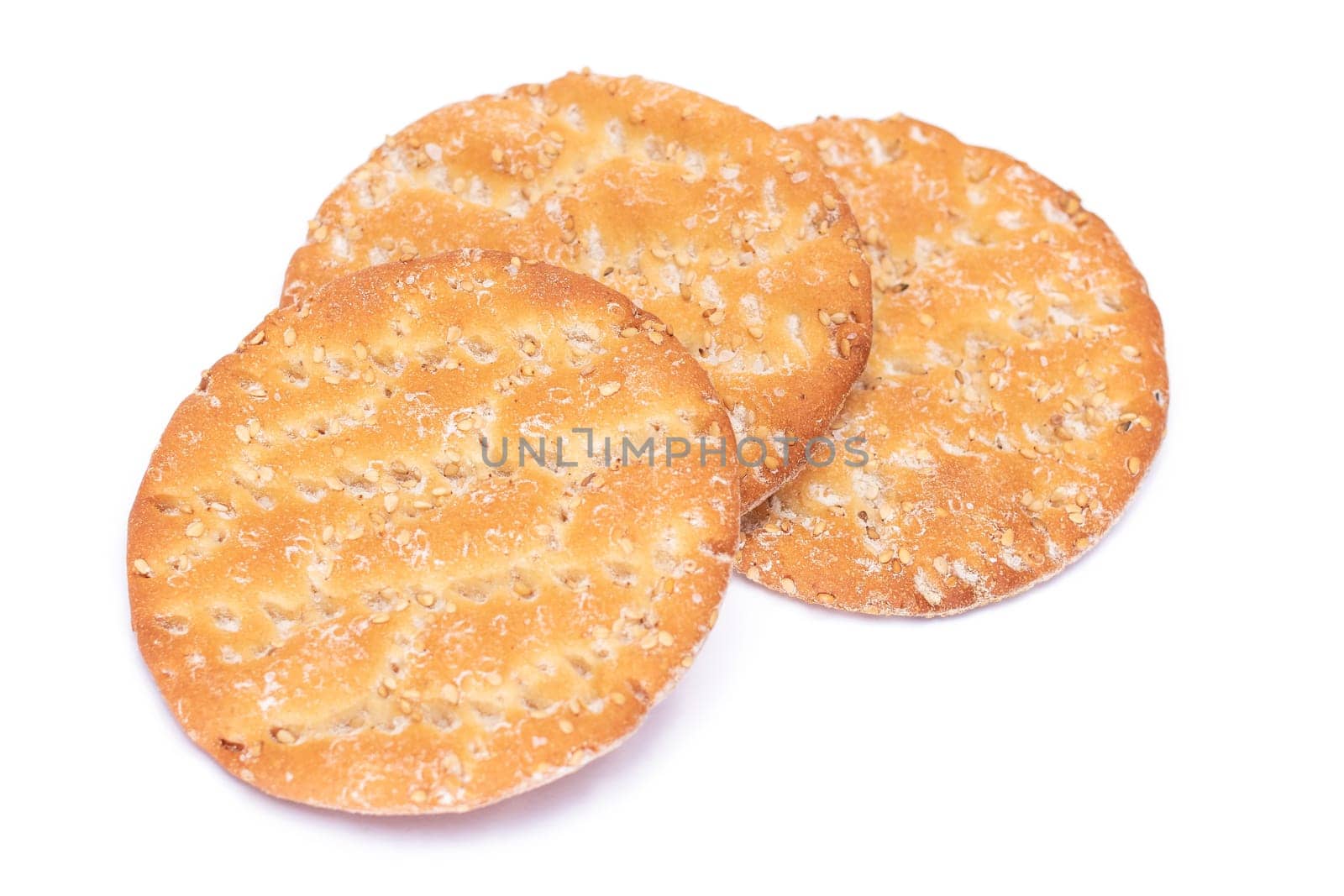 A Heap of Round Salt Crackers with Sesame Isolated on White Background. Dry Snacks - Isolation