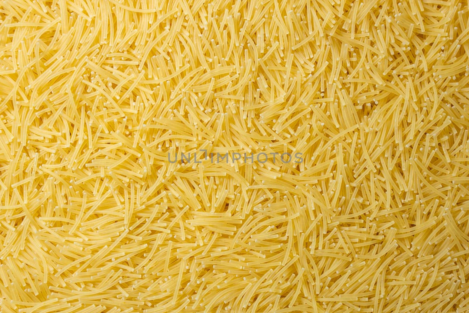 Uncooked Filini Pasta: A Culinary Canvas of Noodles, Creating a Lively and Textured Background for Gourmet Cooking. Dry Pasta. Raw Macaroni - Top View, Flat Lay
