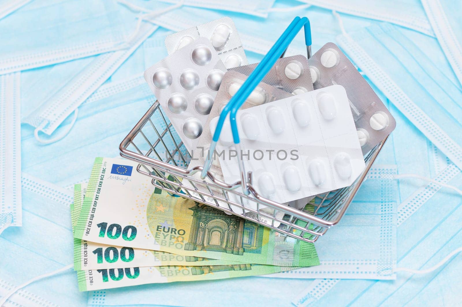 Pills and Capsules in Shopping Basket on the Surgical Masks by InfinitumProdux