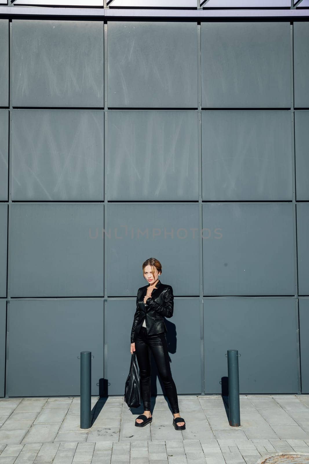 fashionable slender woman walking around the city portrait