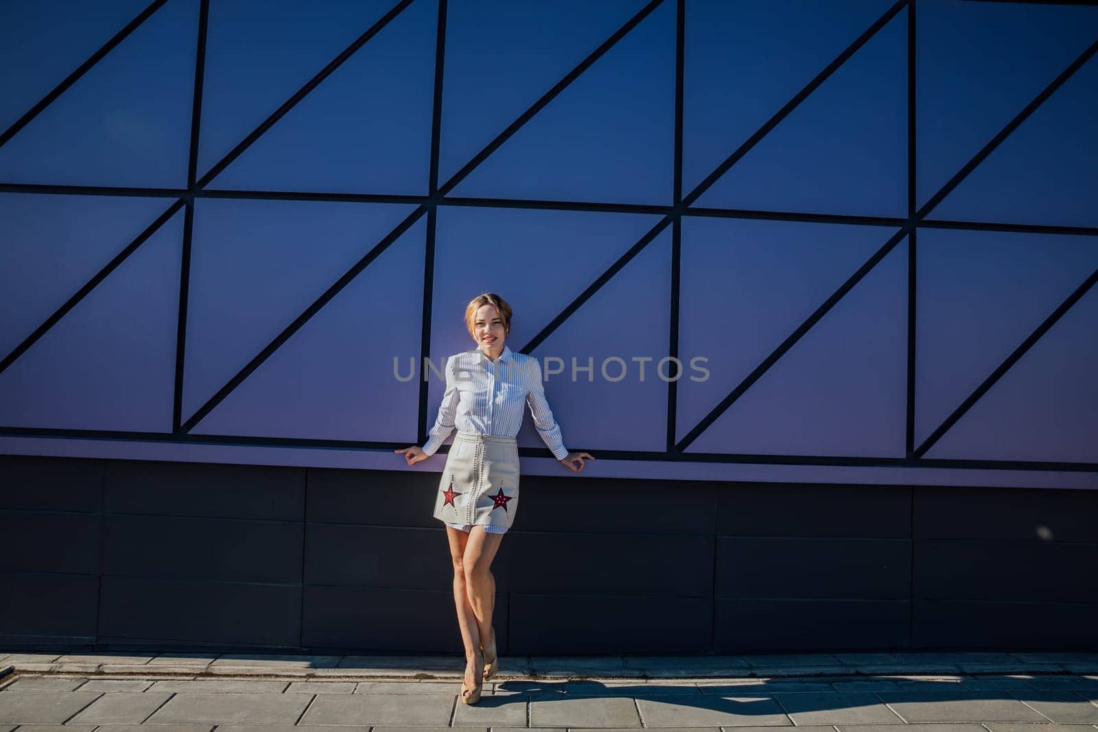 Beautiful fashionable slender woman walking around the city portrait by Simakov