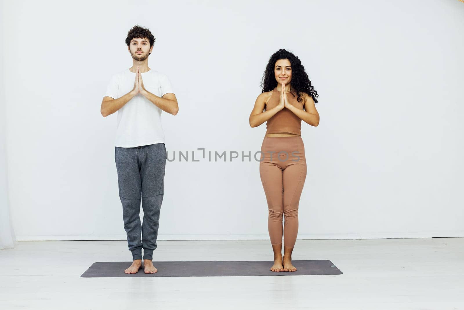 Man And Woman Doing Couple Yoga Fitness Gymnastics Asana by Simakov