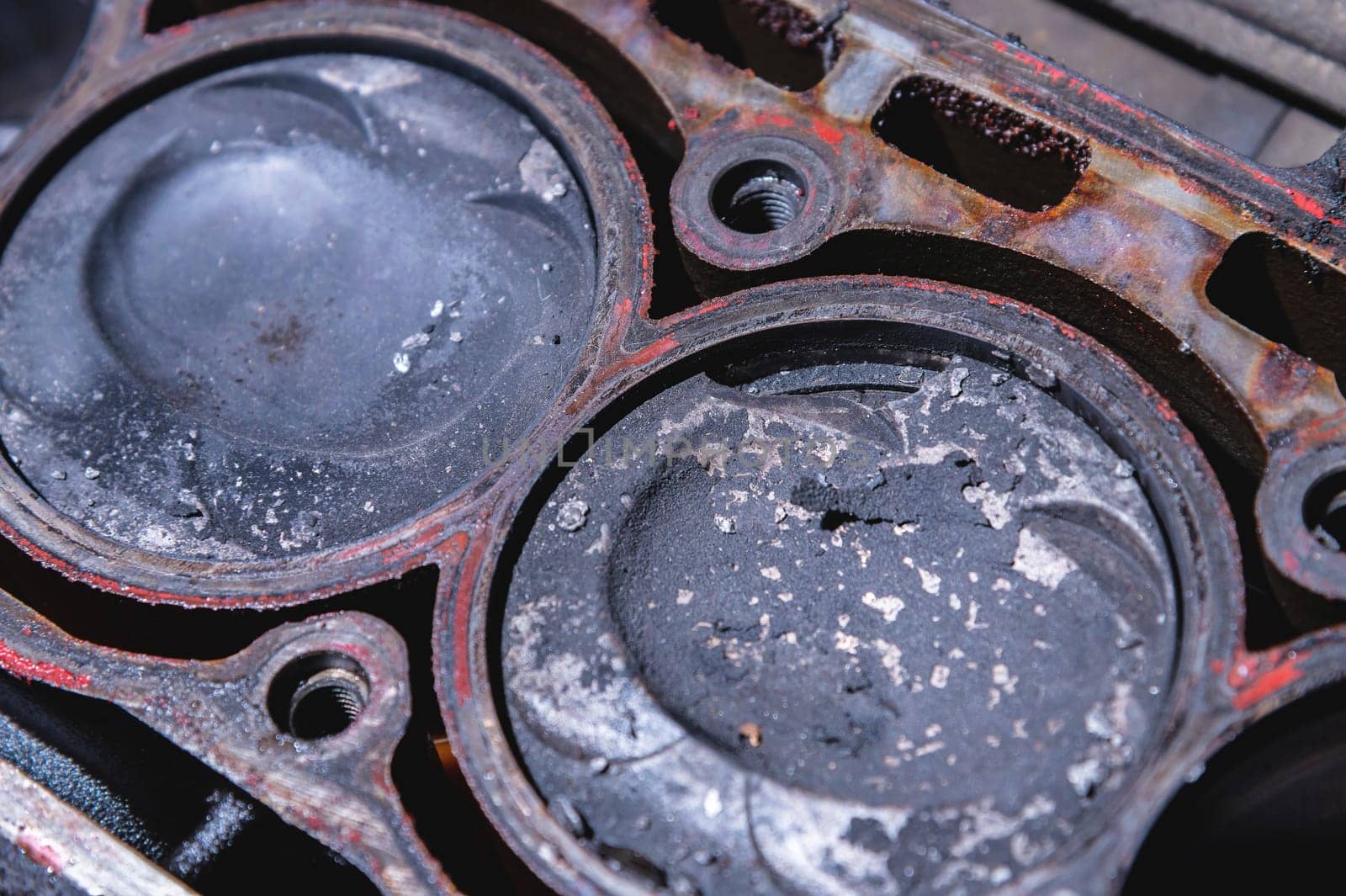 Close-up of a damaged piston of an internal combustion engine with carbon deposits in the cylinder block of a faulty engine by yanik88