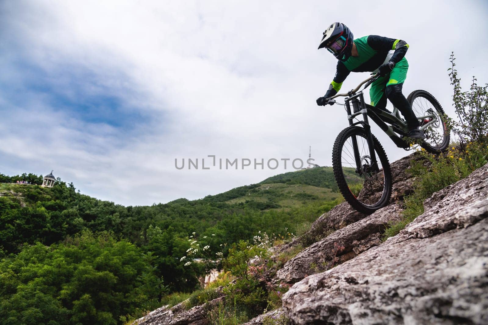 Sport. Cyclist against the sky. A young man rides a mountain bike in beautiful nature.Downhill, MTB. Extreme sport by yanik88