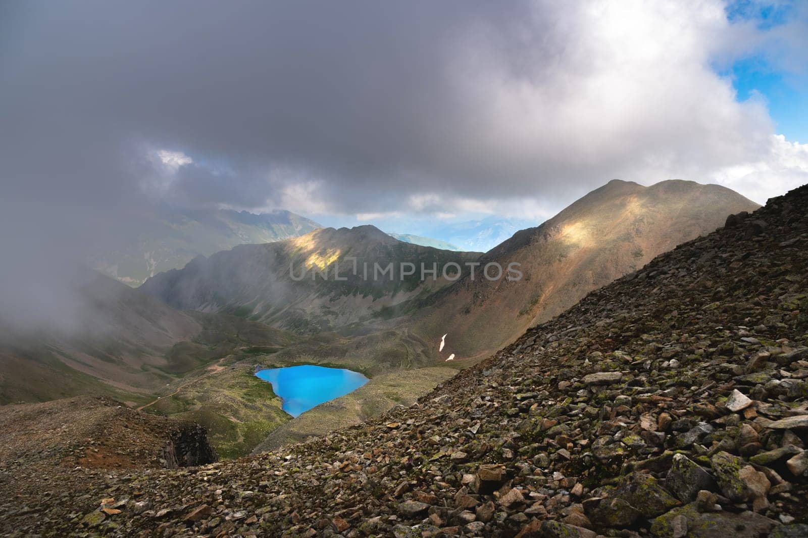 View of a turquoise colored lake between high and rocky mountains. Beautiful alpine landscape by yanik88