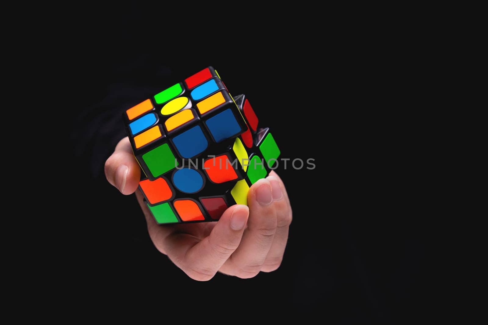 Rubik's cube in the hands of a girl close-up. Young woman trains her brain and develops thinking by yanik88