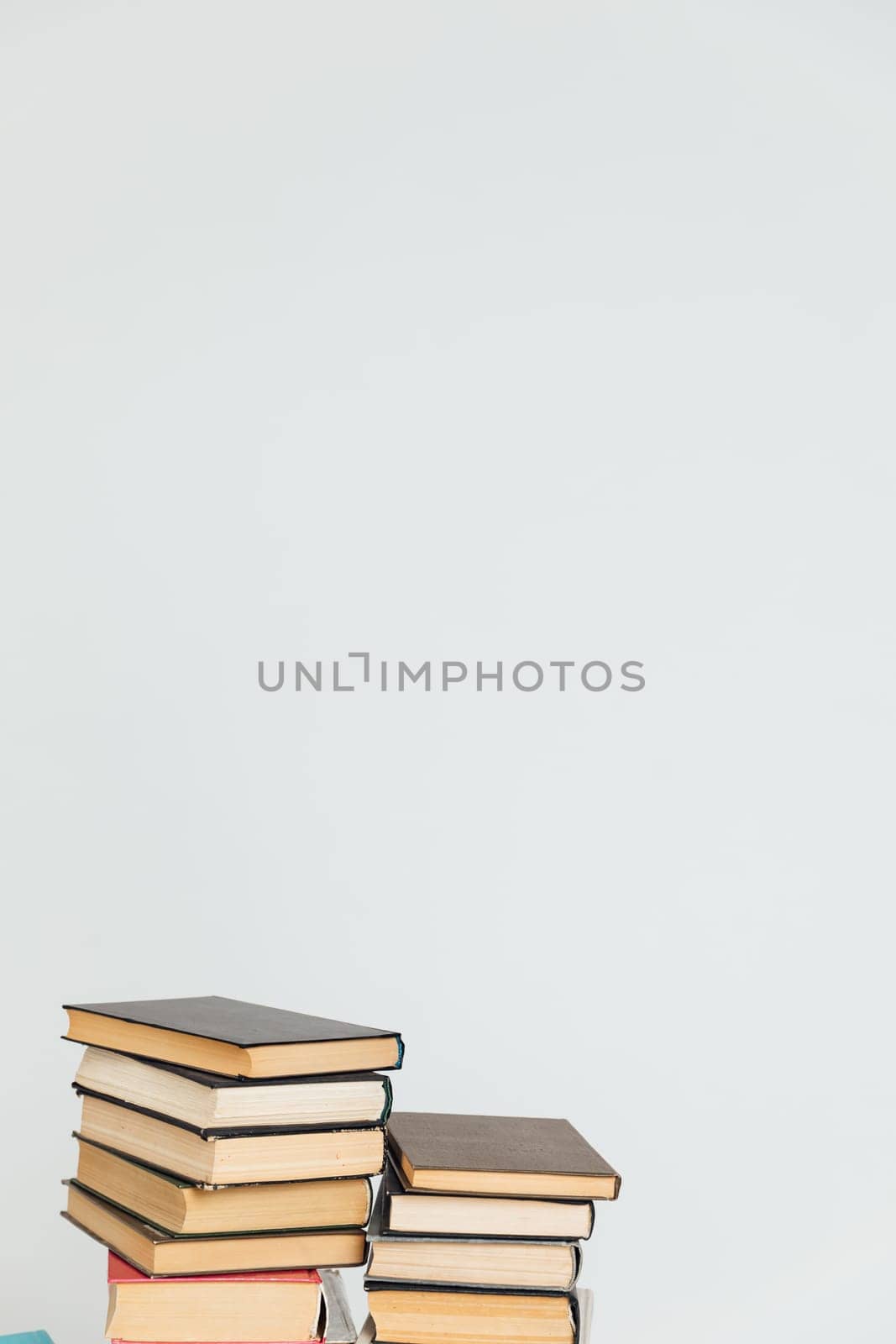 Lots of stacks of old books on white background university school library