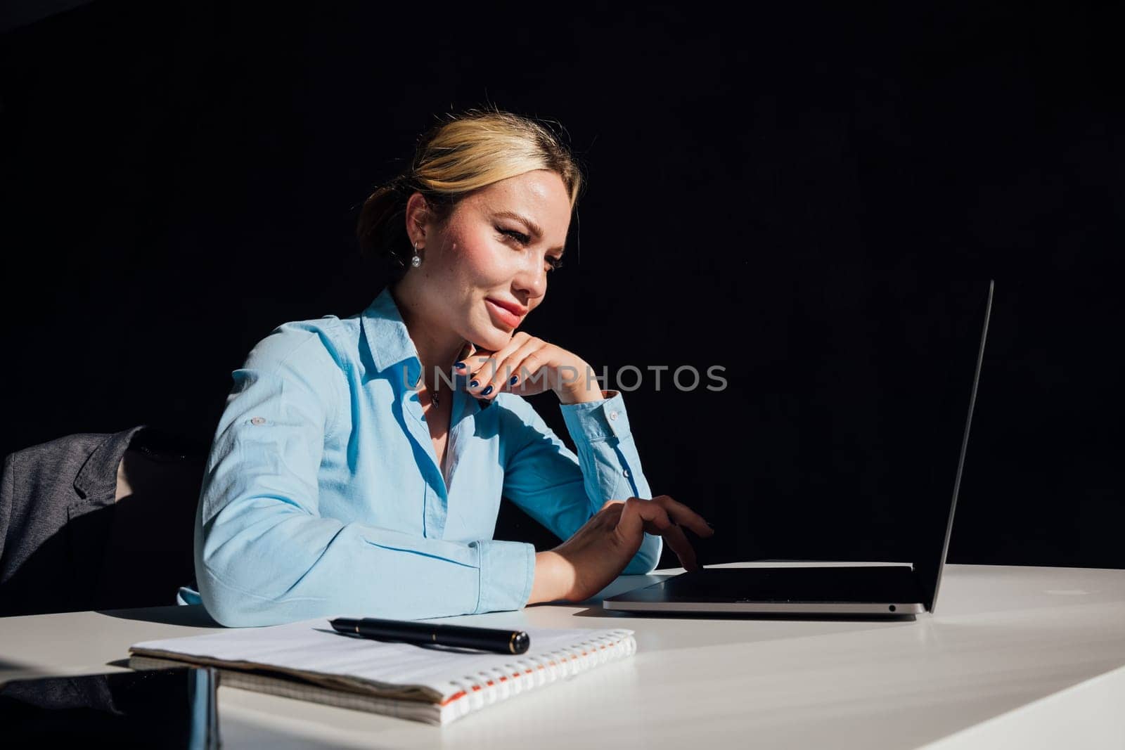 Stylish Female Working on Laptop Computer in a Company Office in the Evening. Young Manager Browsing Internet, Shopping Online and Reading Social Media Posts from Friends and Colleagues.