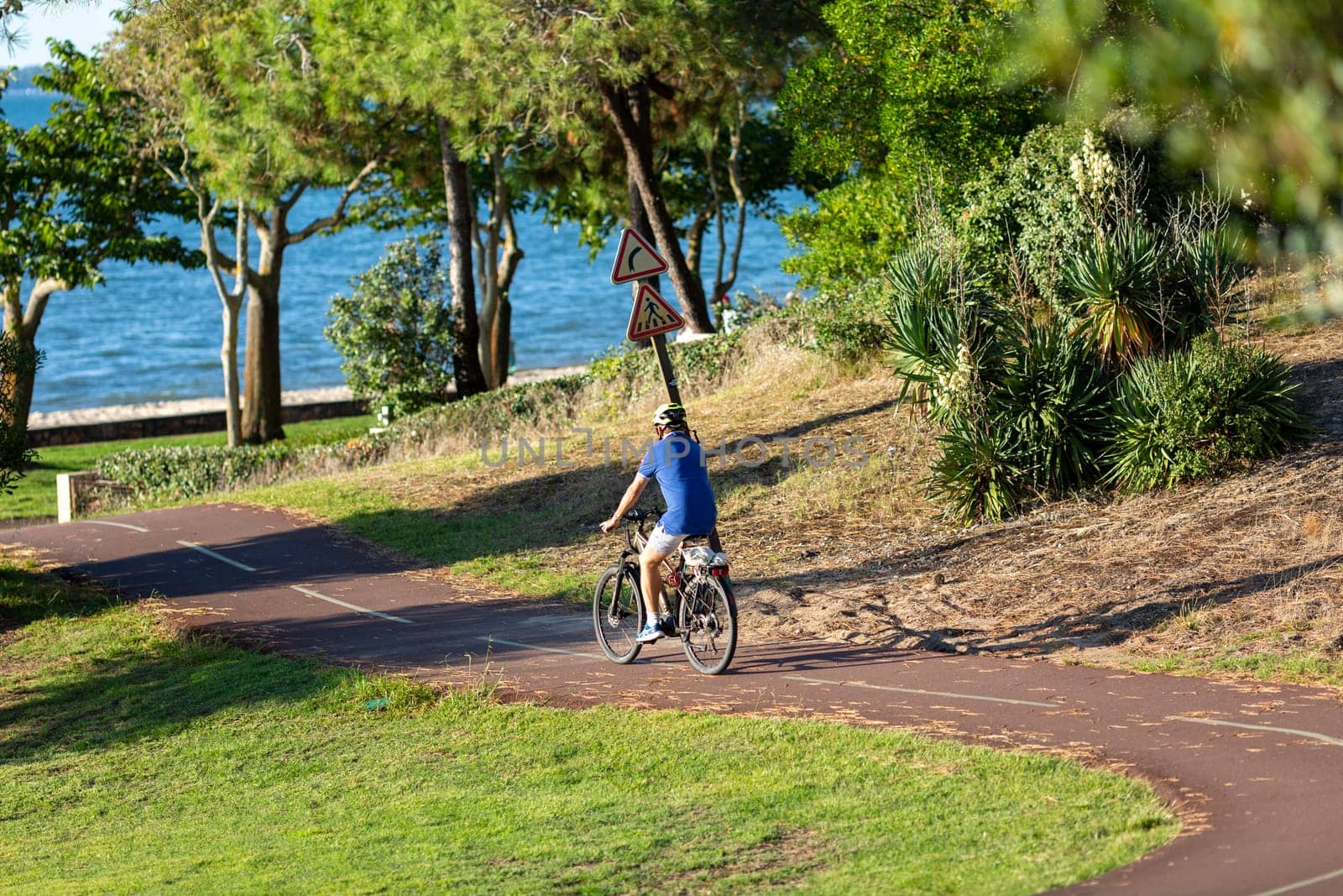 Person riding a bicycle on a cycle path a sunny day