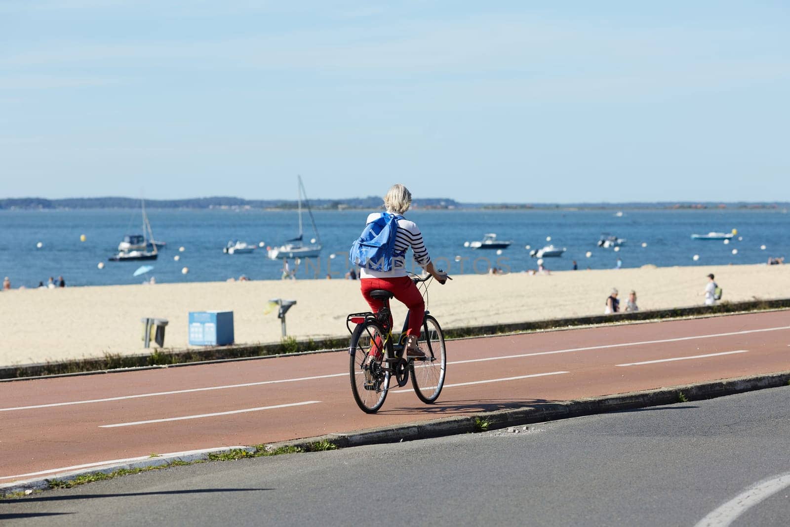 Person riding a bicycle on a cycle path a sunny day