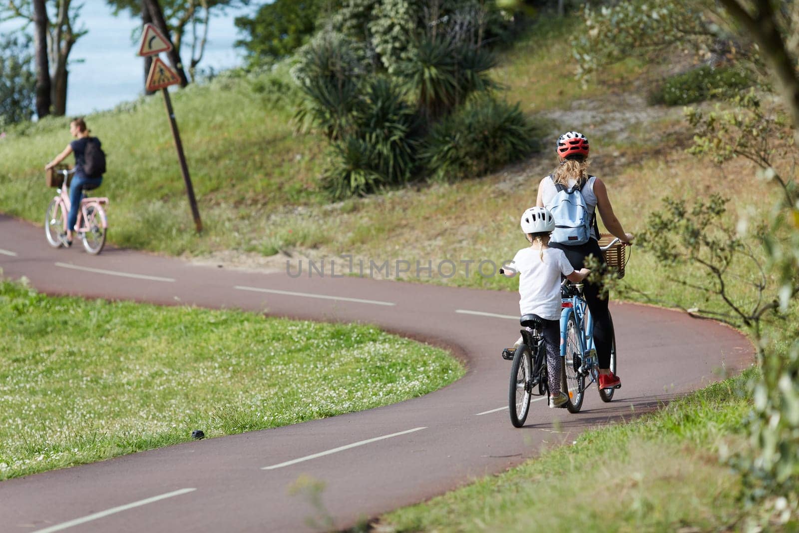 Person riding a bicycle on a cycle path a sunny day