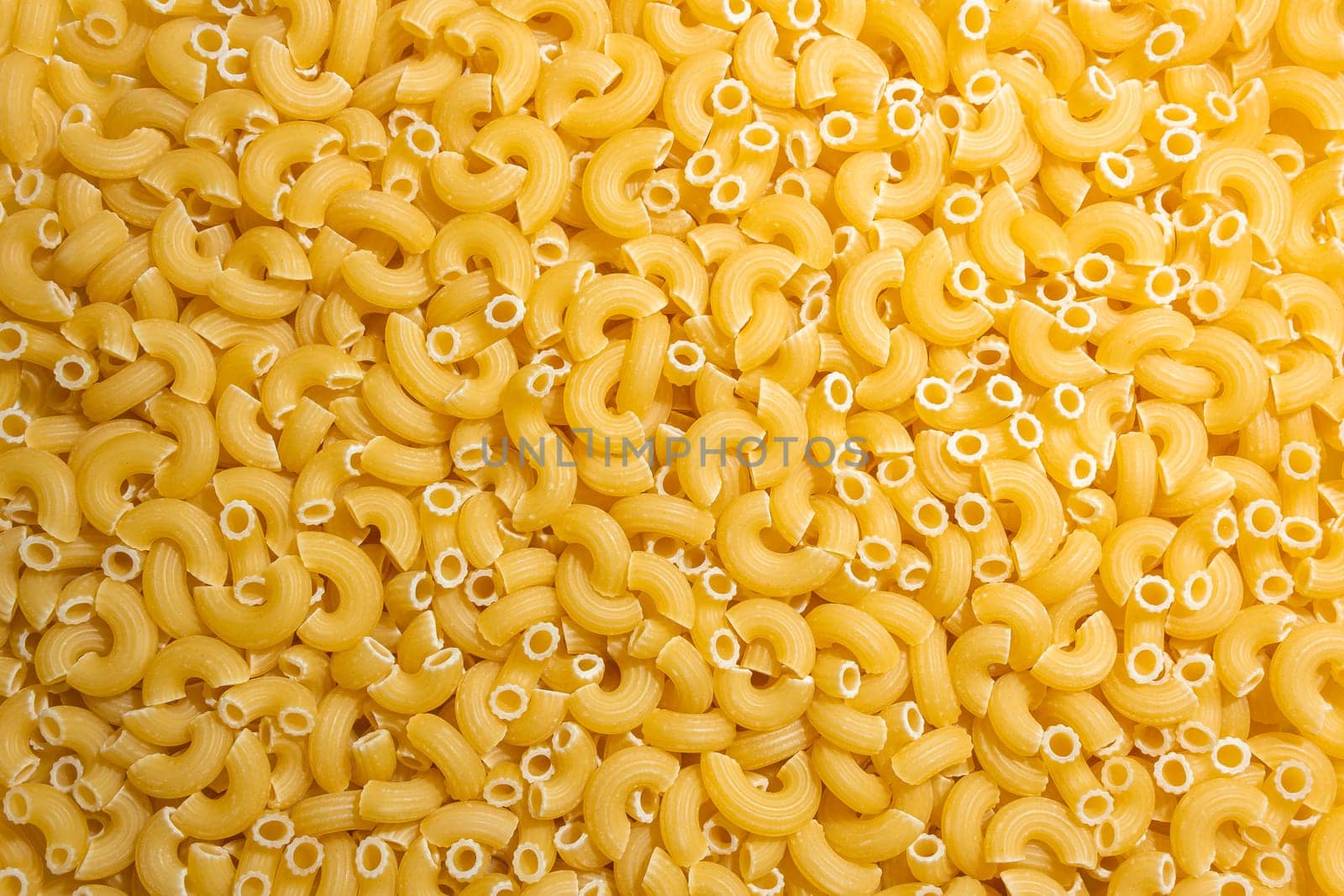 Uncooked Chifferi Rigati Pasta Background by InfinitumProdux