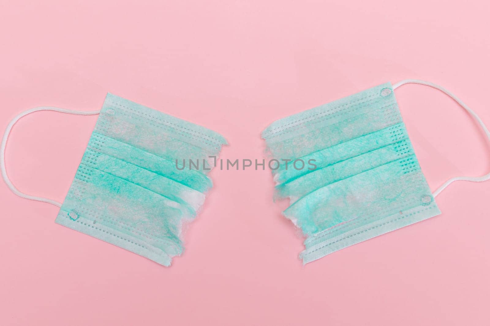 Green Torn Medical Face Mask on the Pink Background by InfinitumProdux