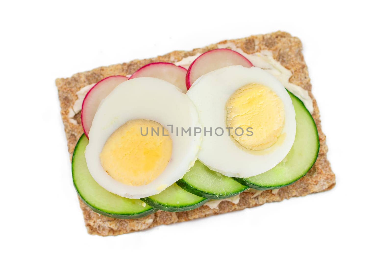 Whole Grain Crispbread with Fresh Cucumber, Egg, Cream Cheese and Radish - Isolated by InfinitumProdux