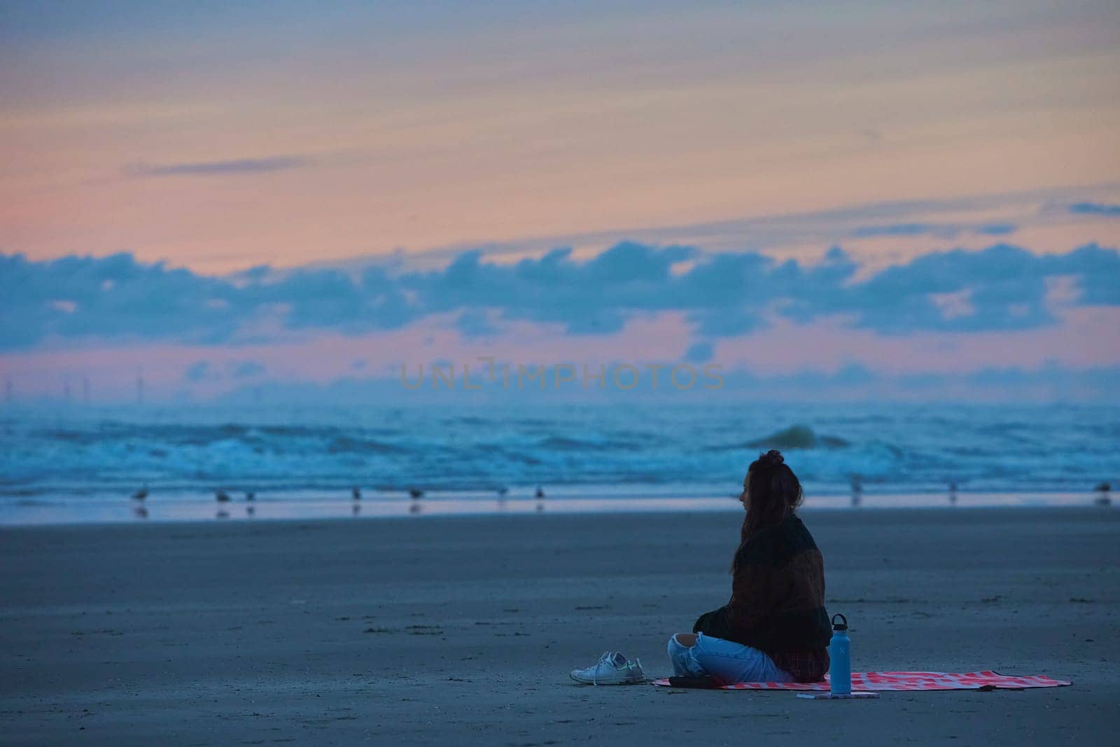 Velsen-Noord, Netherlands,August 30,2023: Girl meditating on the beach by Viktor_Osypenko