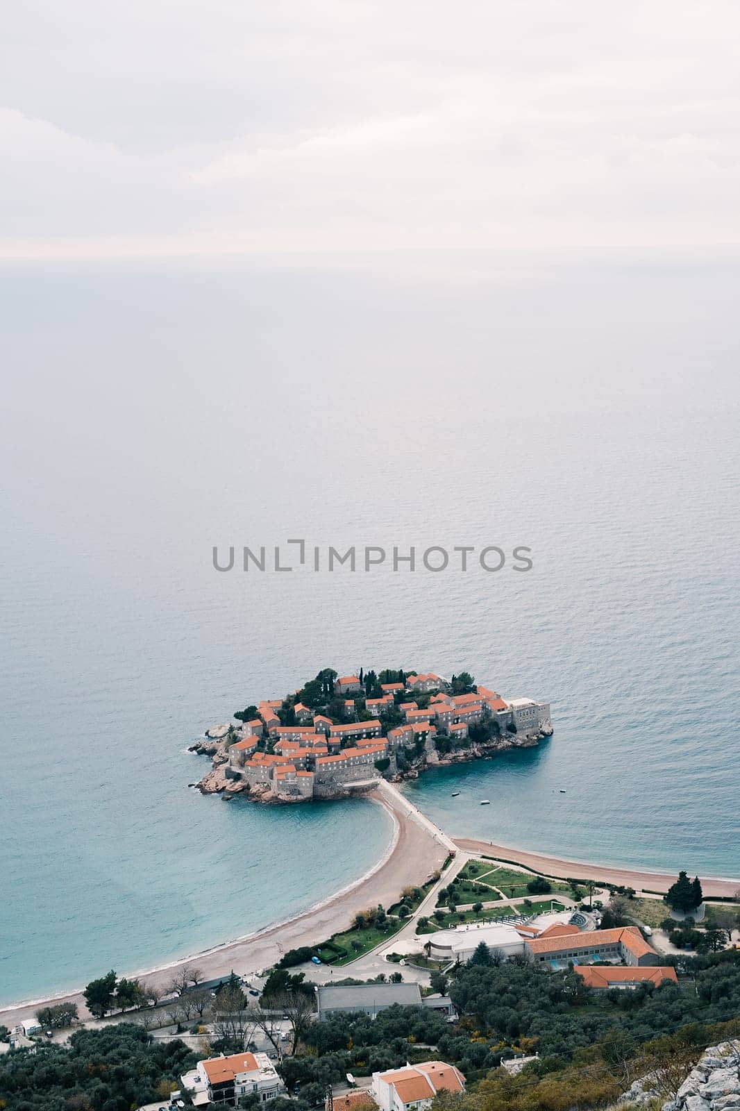 Island of Sveti Stefan is connected by an isthmus to the mainland. Top view. Montenegro. High quality photo