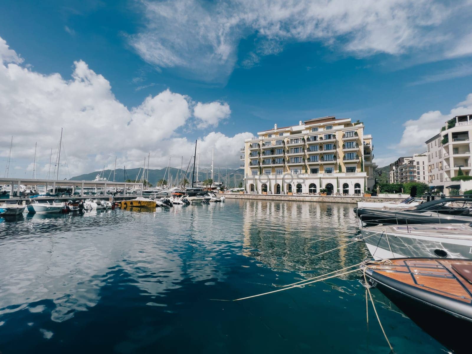 Tivat, Montenegro - 11 august 2023: Marina with moored yachts near the Regent Hotel. Porto, Montenegro by Nadtochiy