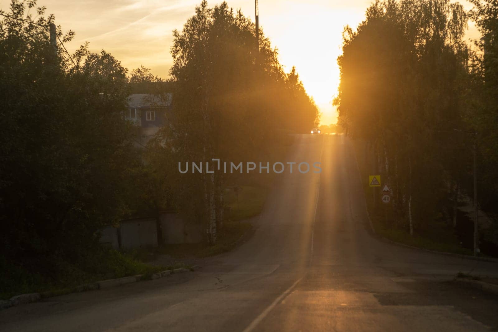 Empty city road at sunset. The road goes up. Success and growth concept. Beautiful city background