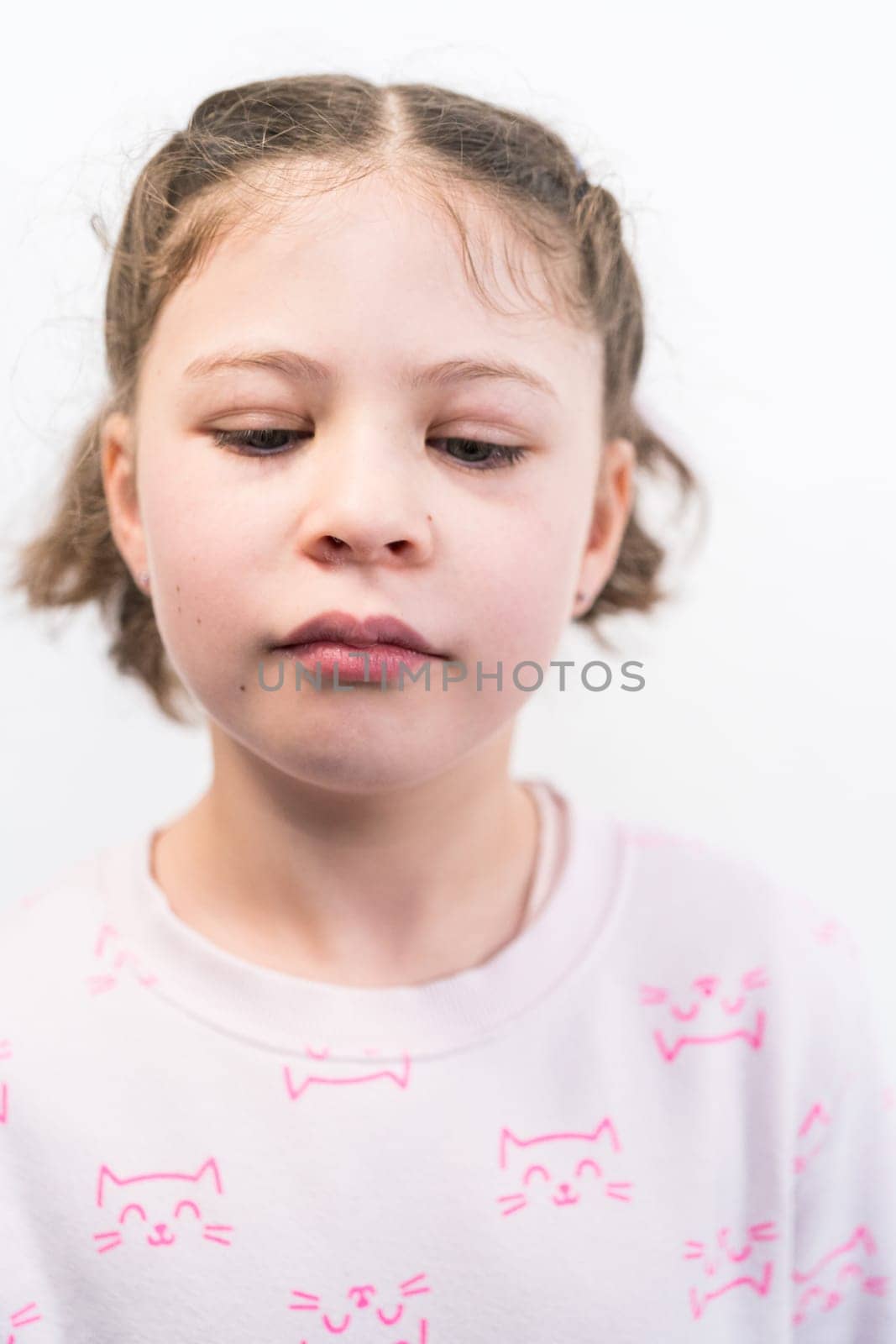 Little girl with rainbow braces smiling at the camera.