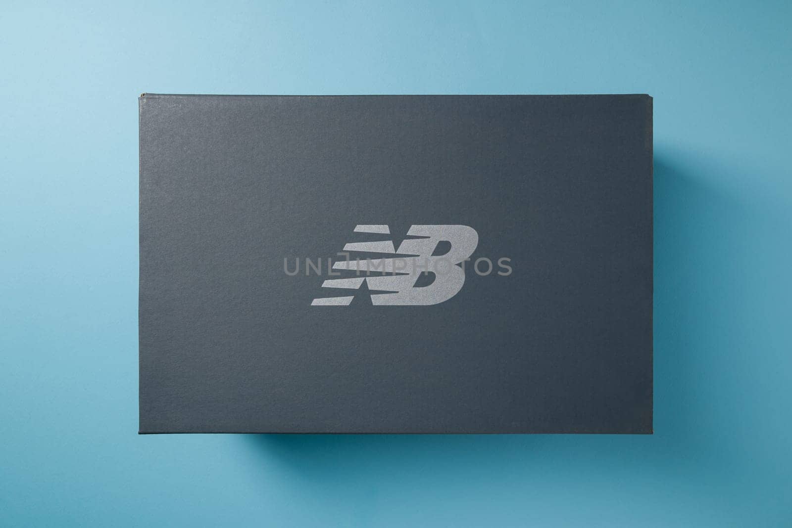 Antalya, Turkey - December 1, 2023: Sneaker box with New Balance logo. on blue background by Sonat