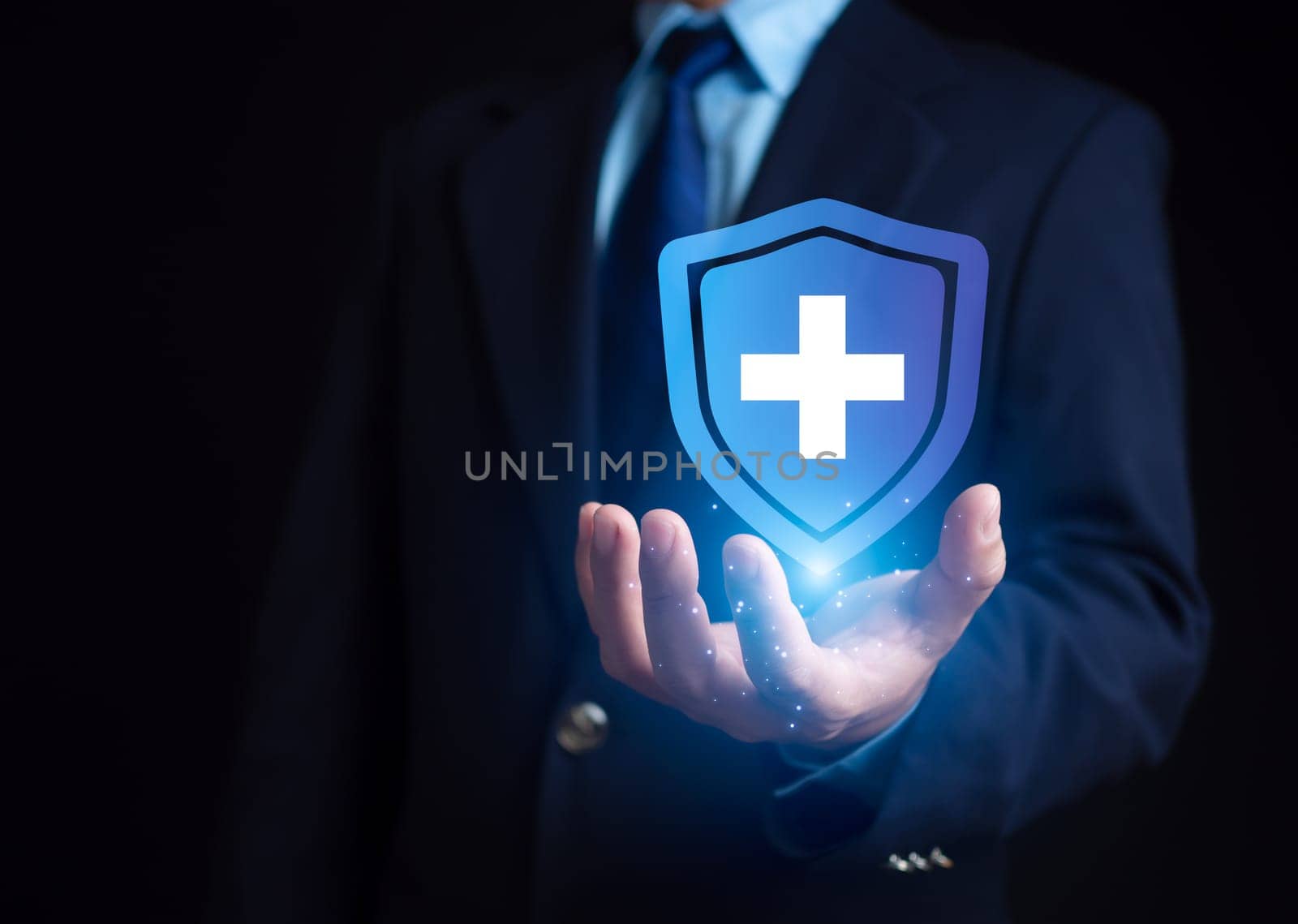 The concept of health insurance and Medical welfare, Businessman is holding plus icon represents protection Receiving benefits. Health insurance and access to treatment. health care planning by Unimages2527