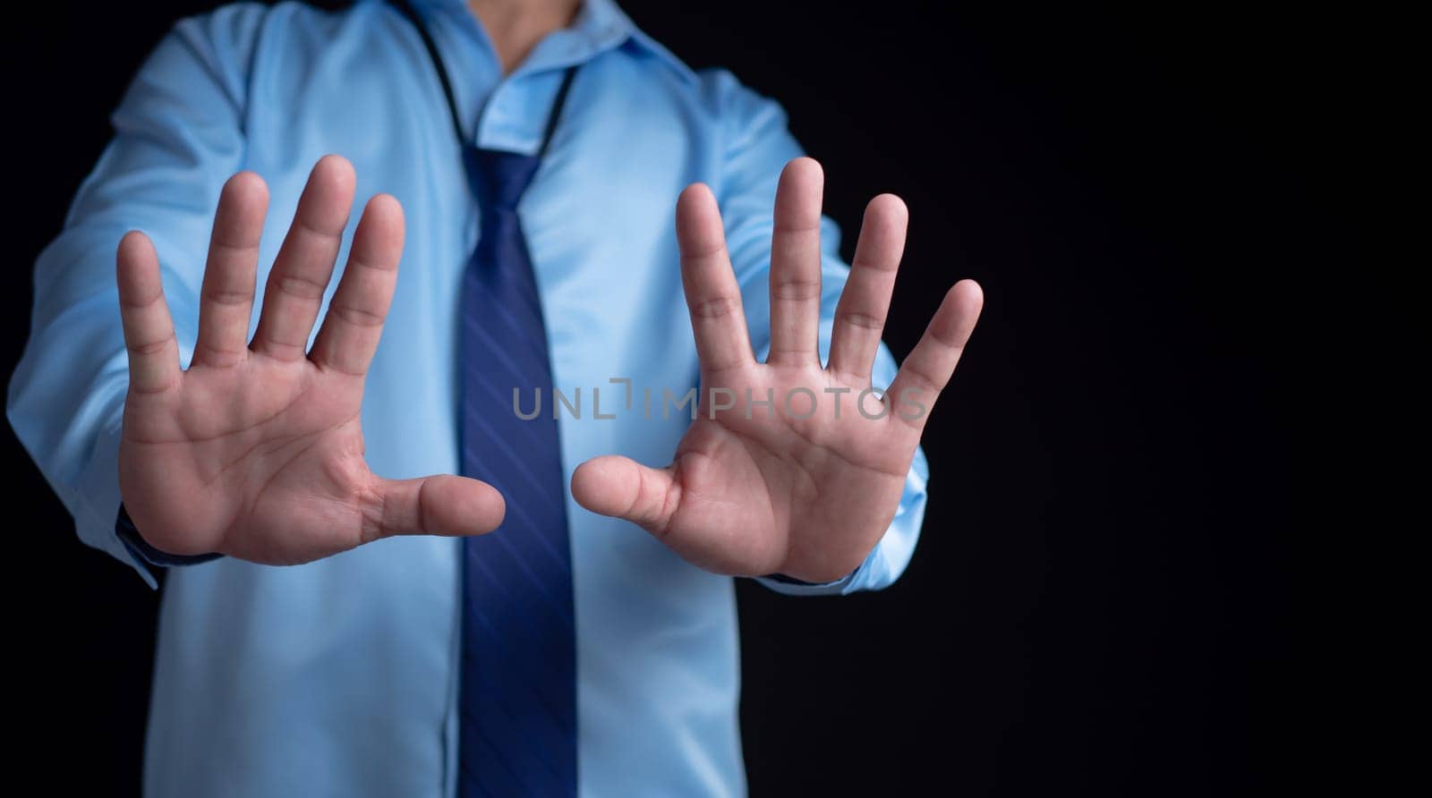 Office worker showing palm showing stop gesture, taking a break, taking a break to reduce stress.