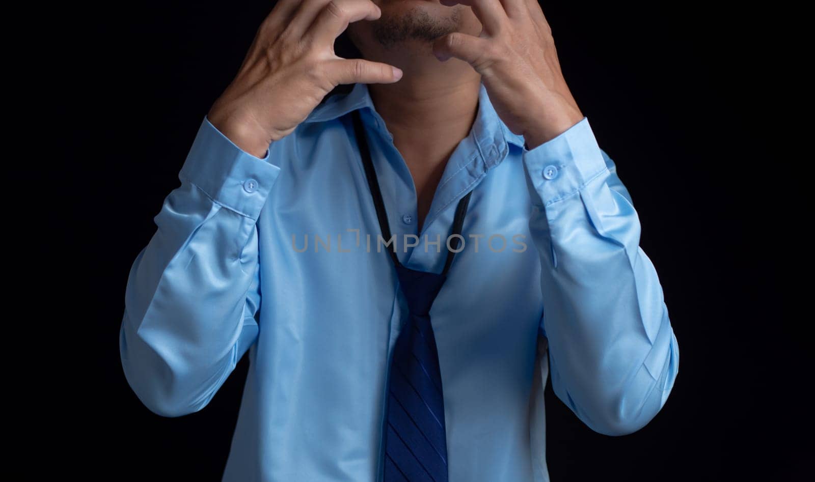 Businessman acted tired headache stressed and anxious from the frustrated business crisis, expresses disappointment, regret, making a mistake. by Unimages2527