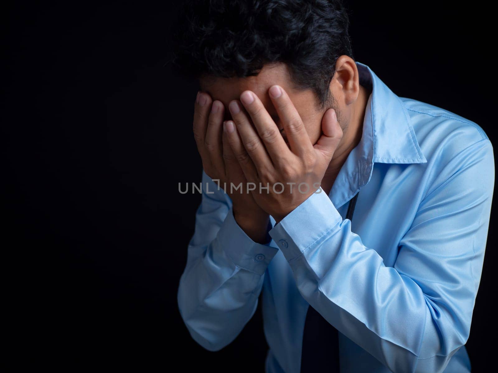 Businessman acted tired headache stressed and anxious from the frustrated business crisis, expresses disappointment, regret, making a mistake. by Unimages2527