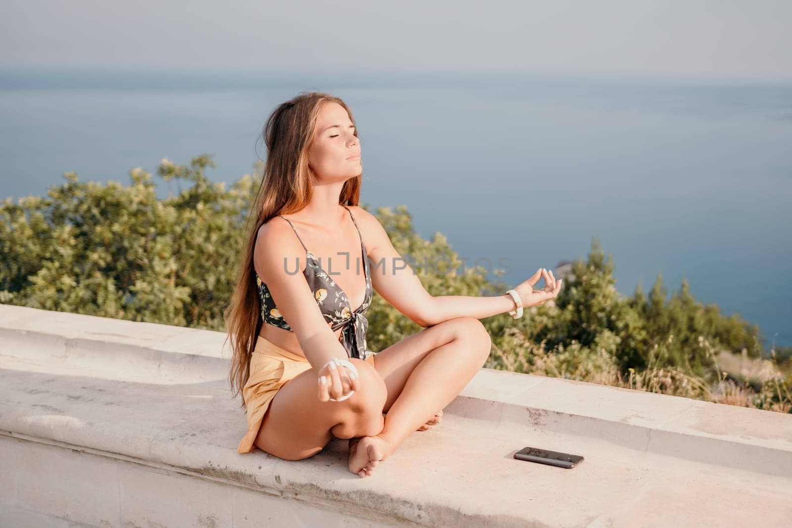 Woman park yoga. Side view of free calm bliss satisfied woman with long hair standing in morning park with yoga position against of sky by the sea. Healthy lifestyle outdoors in park, fitness concept