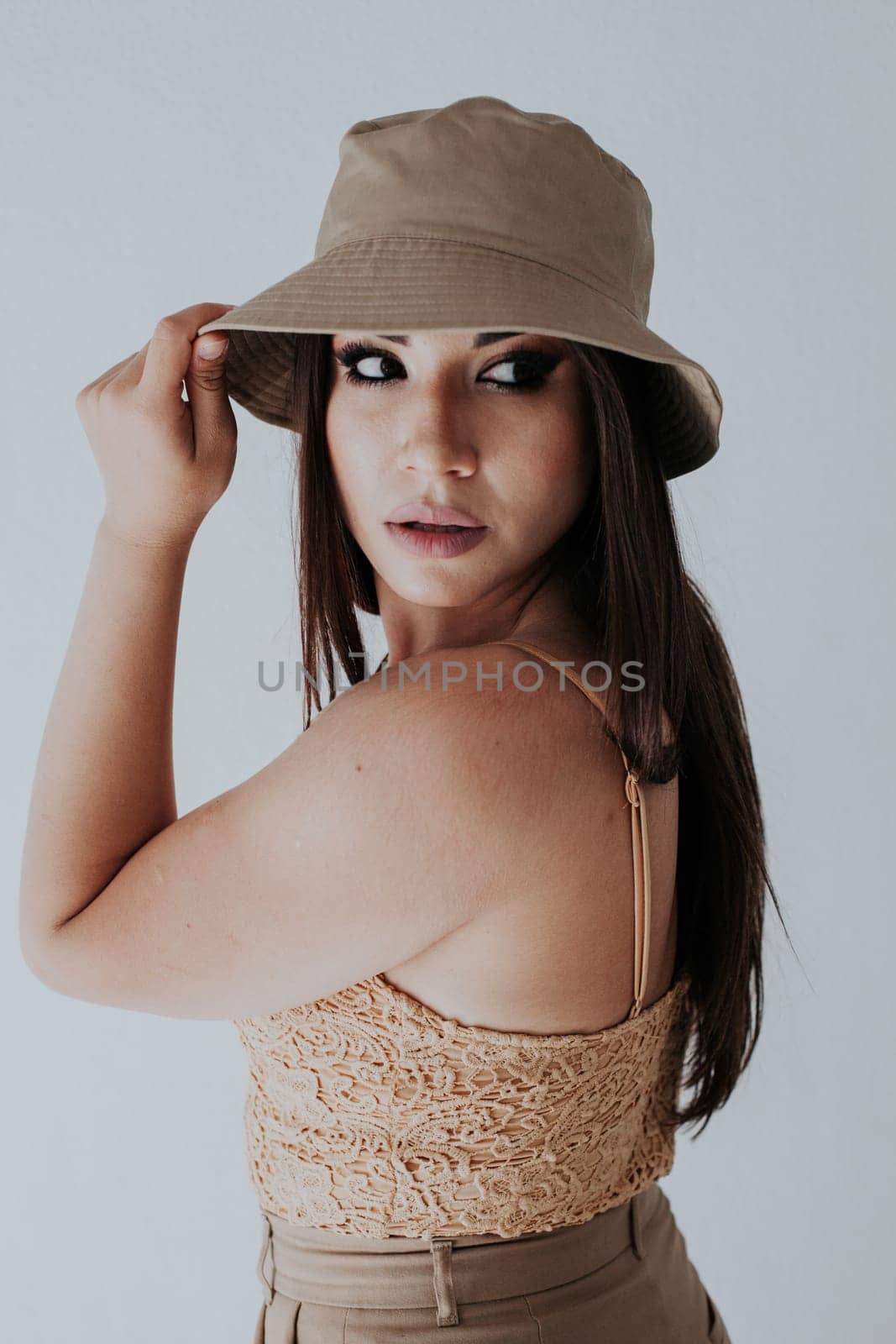 Beautiful fashionable Armenian woman wearing beige clothes and panama hat