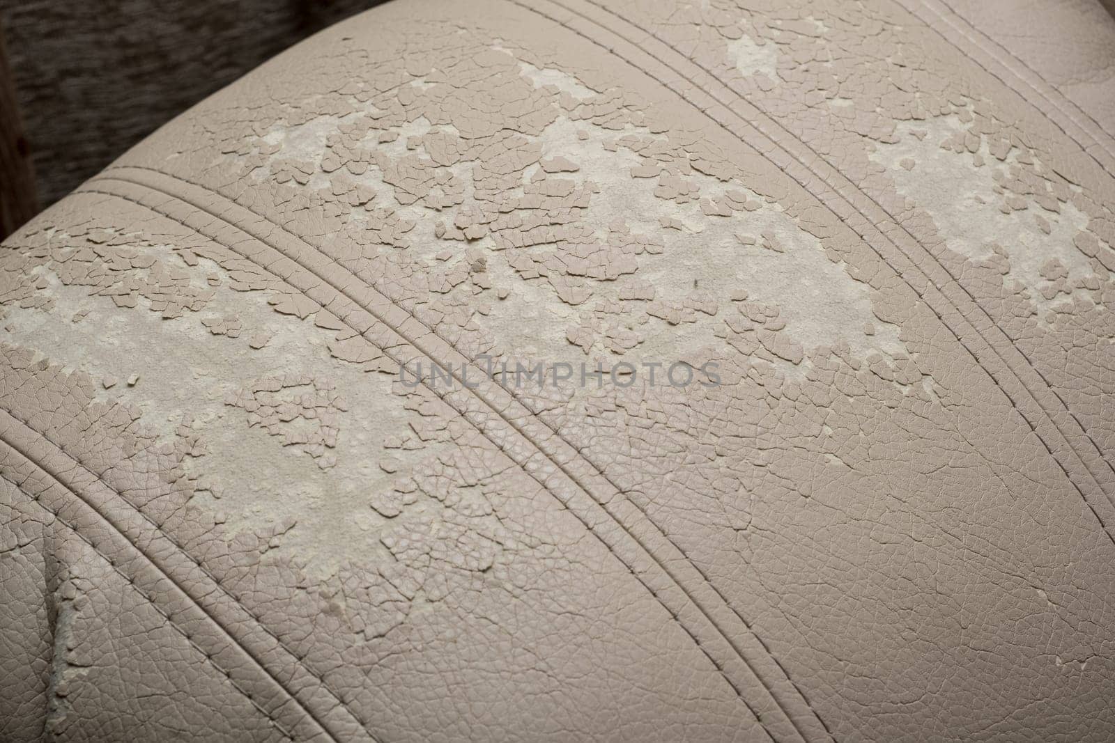 Defects on a white leather sofa. Damaged to leather furniture. by AnatoliiFoto