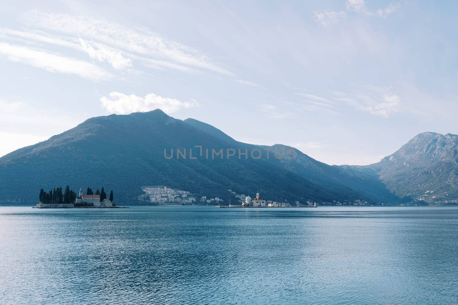 Islands of the Bay of Kotor against the backdrop of mountains and a cloudy sky. Montenegro. High quality photo