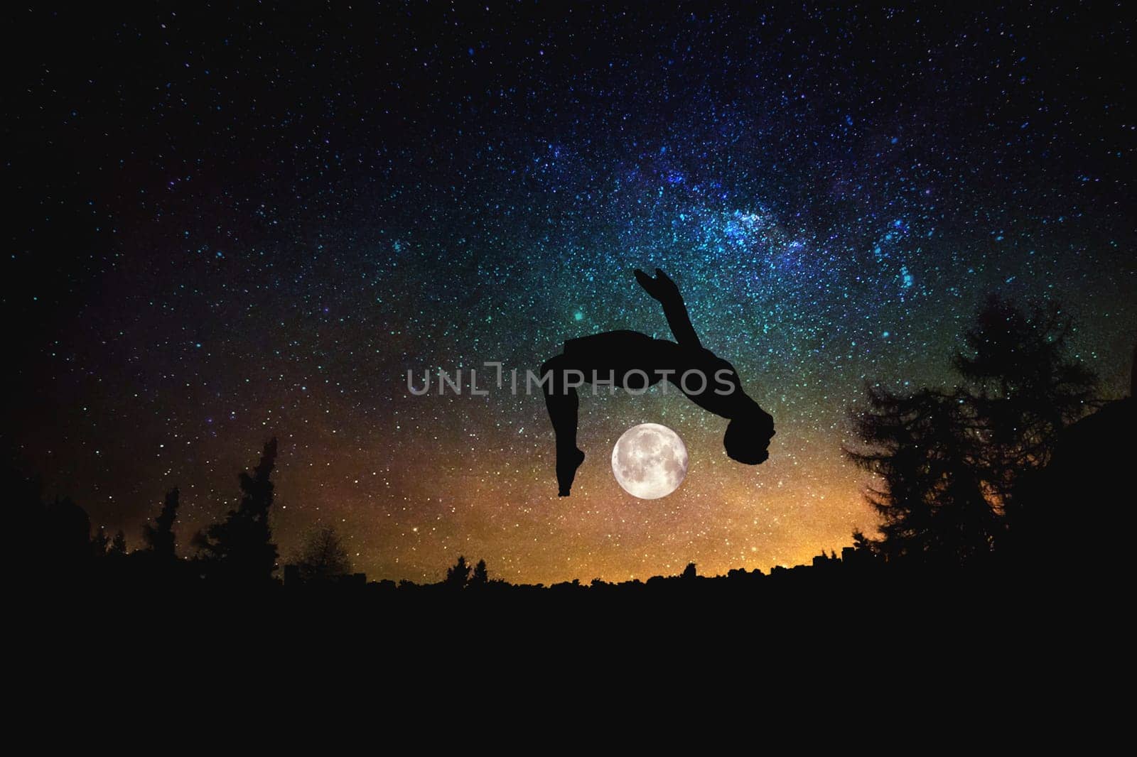 sporty man jumping silhouette at the night starry sky and moon background. Mixed media