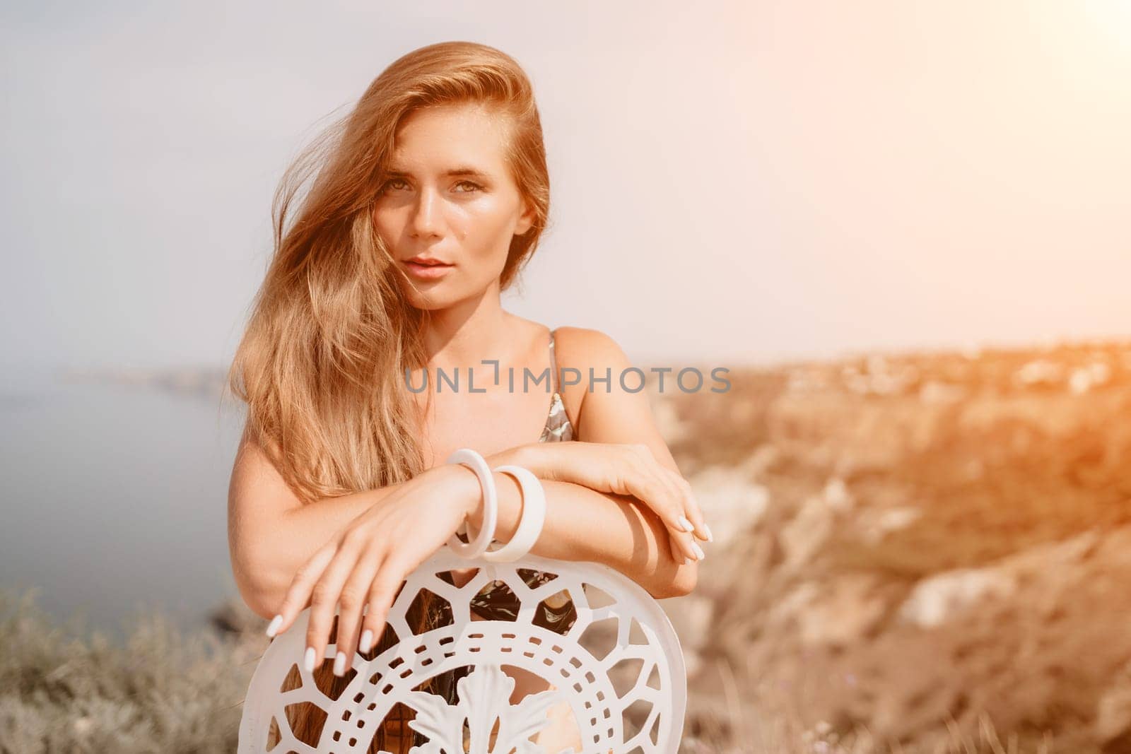 Happy boho woman portrait. Boho chic fashion style. Outdoor photo of free happy woman with long hair, sunny weather outdoors with sea mountains nature beautiful background. by panophotograph
