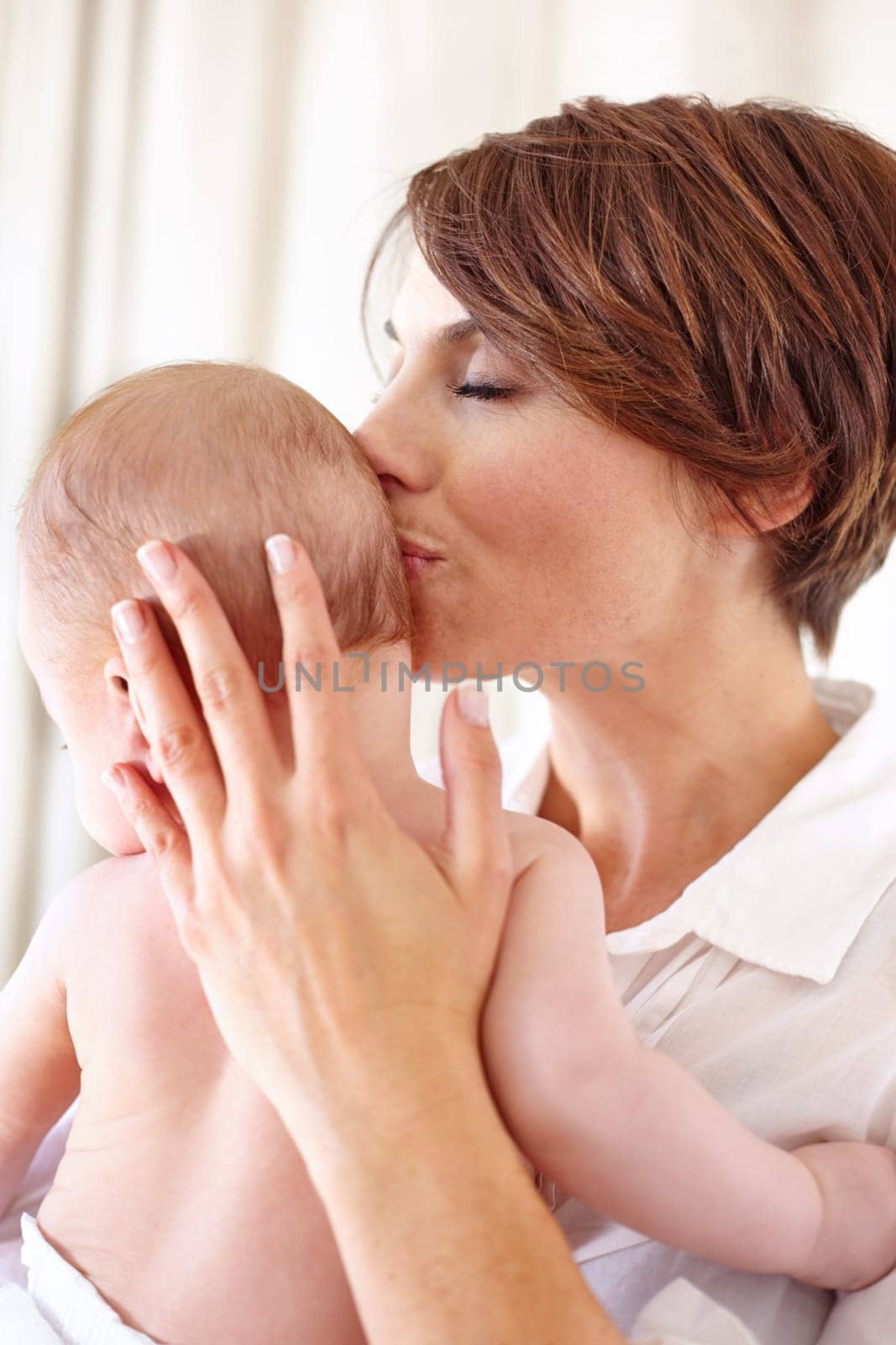 Mother, baby and kiss or love, care and relaxing or play, bonding and joy in parenthood. Mom, kid and motherhood or affection at home, connect and happy for child development, comfort and happiness.