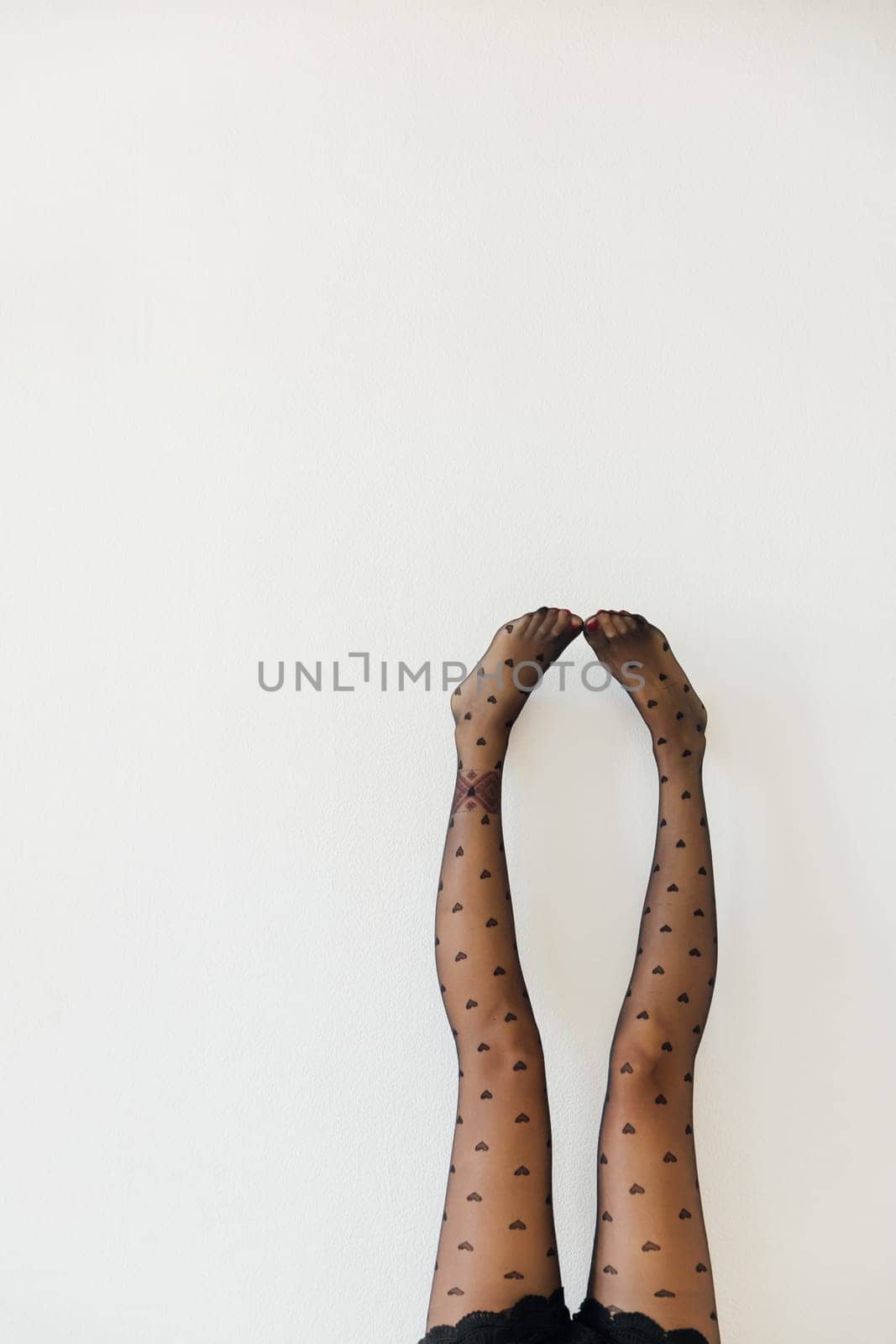 Beautiful slender female legs in black stockings pantyhose by Simakov