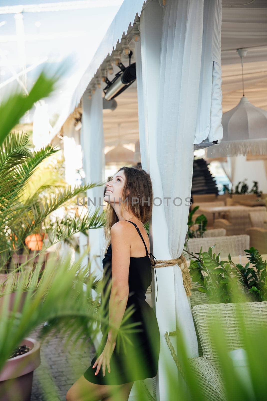 Beautiful woman in black summer dress