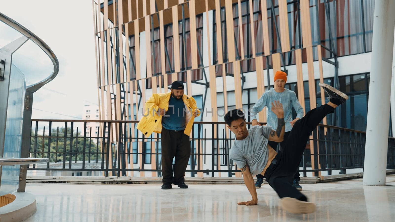 Hip hop team dance break dance while multicultural friend surrounded and clapping hands to cheer or encourage his friend to dance. Active and energetic street dance. Outdoor sport 2024. Endeavor.