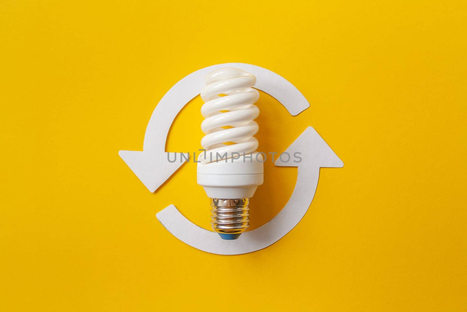 Energy saving light bulb on a orange background by Quils