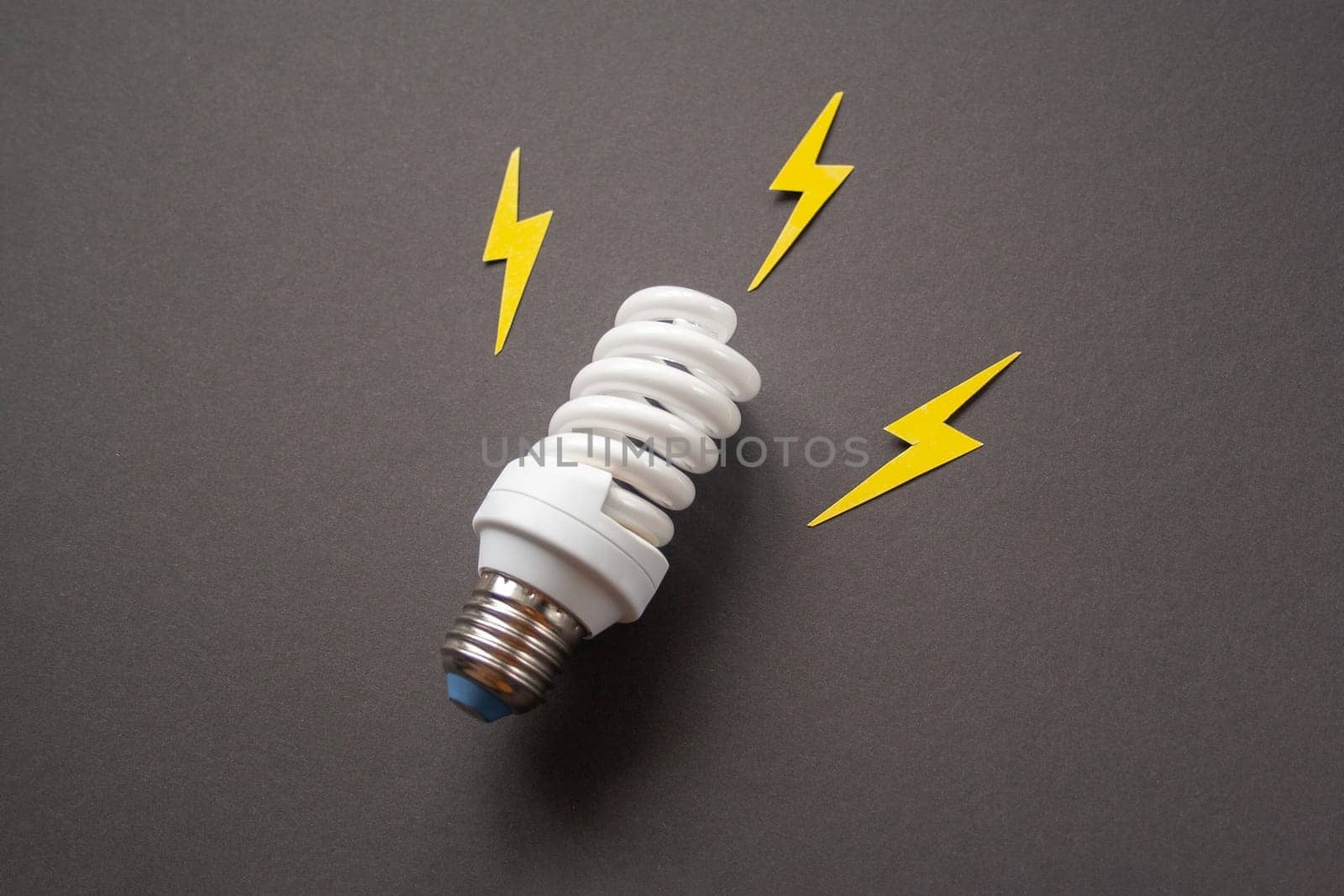 Light bulb with energy lightings on black background. Idea concept. Energy and electricity. Innovation and thinking out the box symbols. Creativity and inspiration