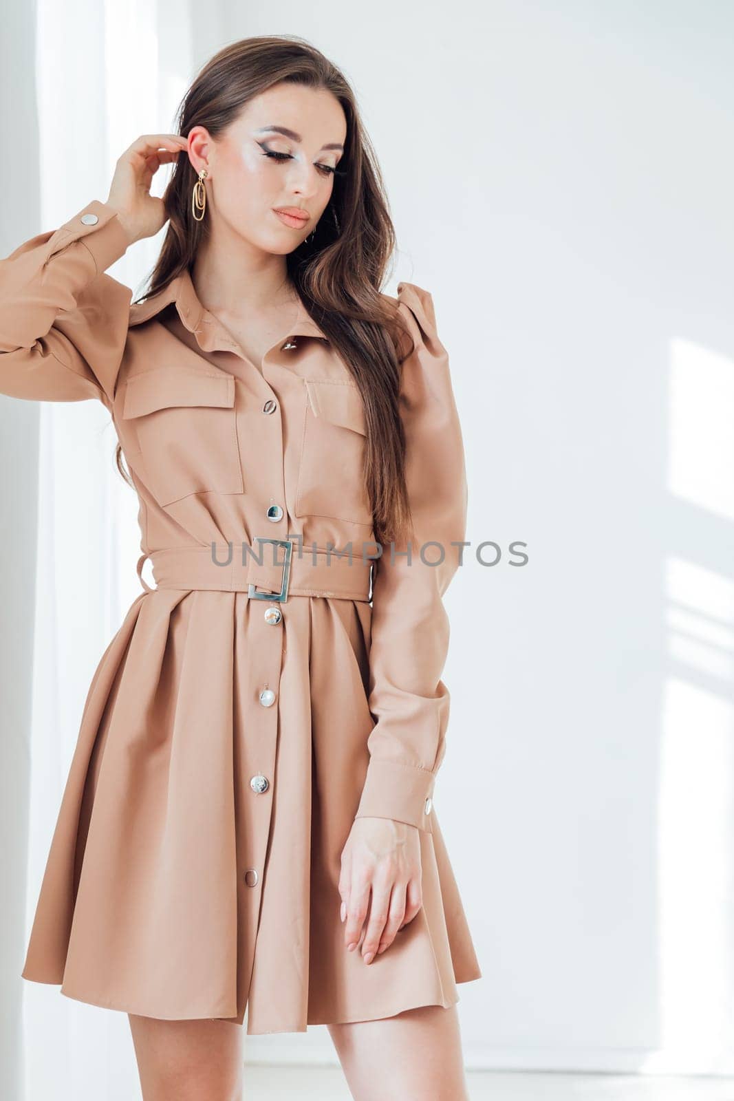 woman in dress posing in bright room