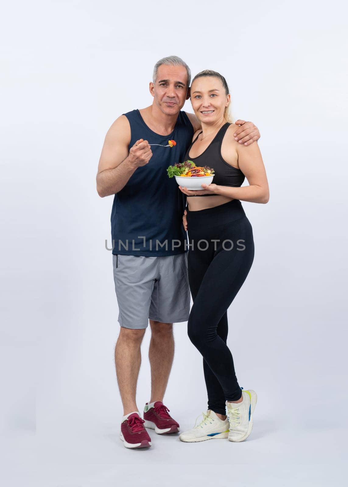 Happy smile senior man and woman portrait holding bowl of vegan. Clout by biancoblue
