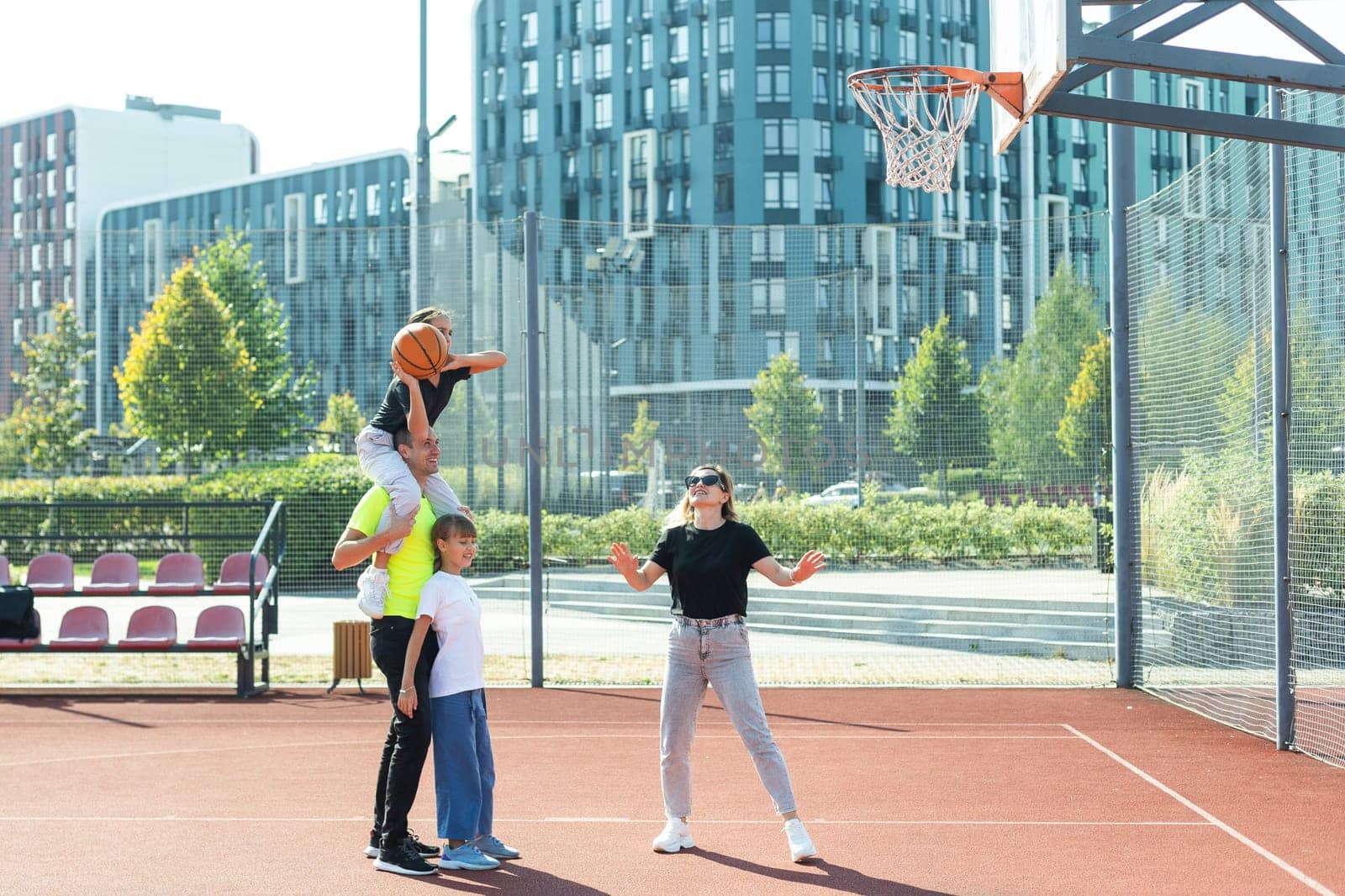 Caucasian family playing basketball together. Happy family spending free time together. High quality photo