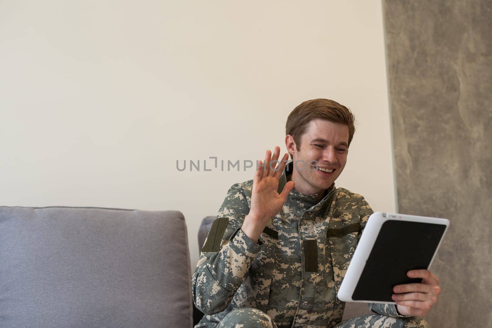 cheerful military man using digital tablet and having video call in office by Andelov13