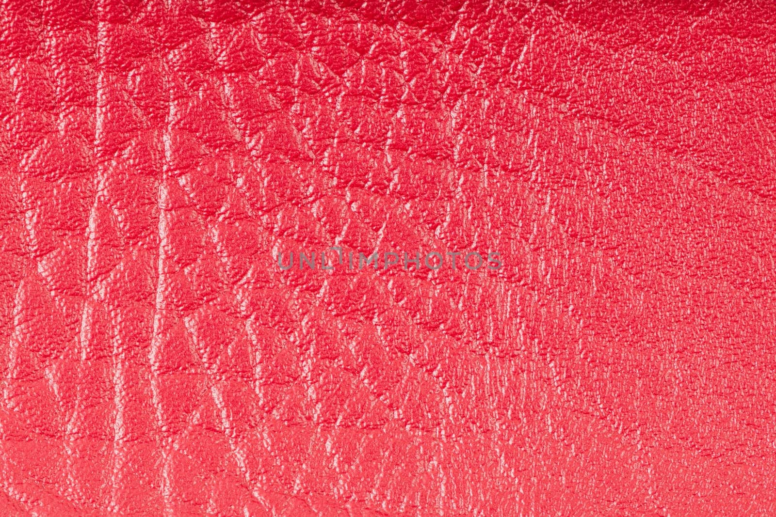 Pink leather texture closeup detailed background.