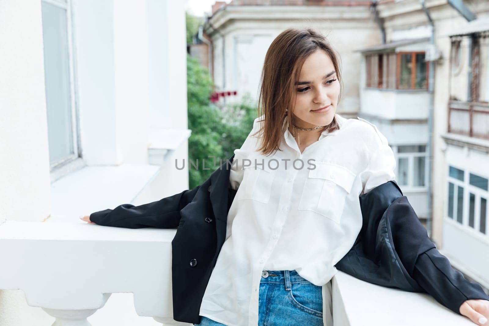 woman stands on the balcony of the room